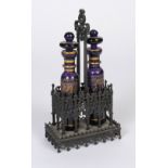 A Bohemian Gothic revival cast iron and glass cruet,