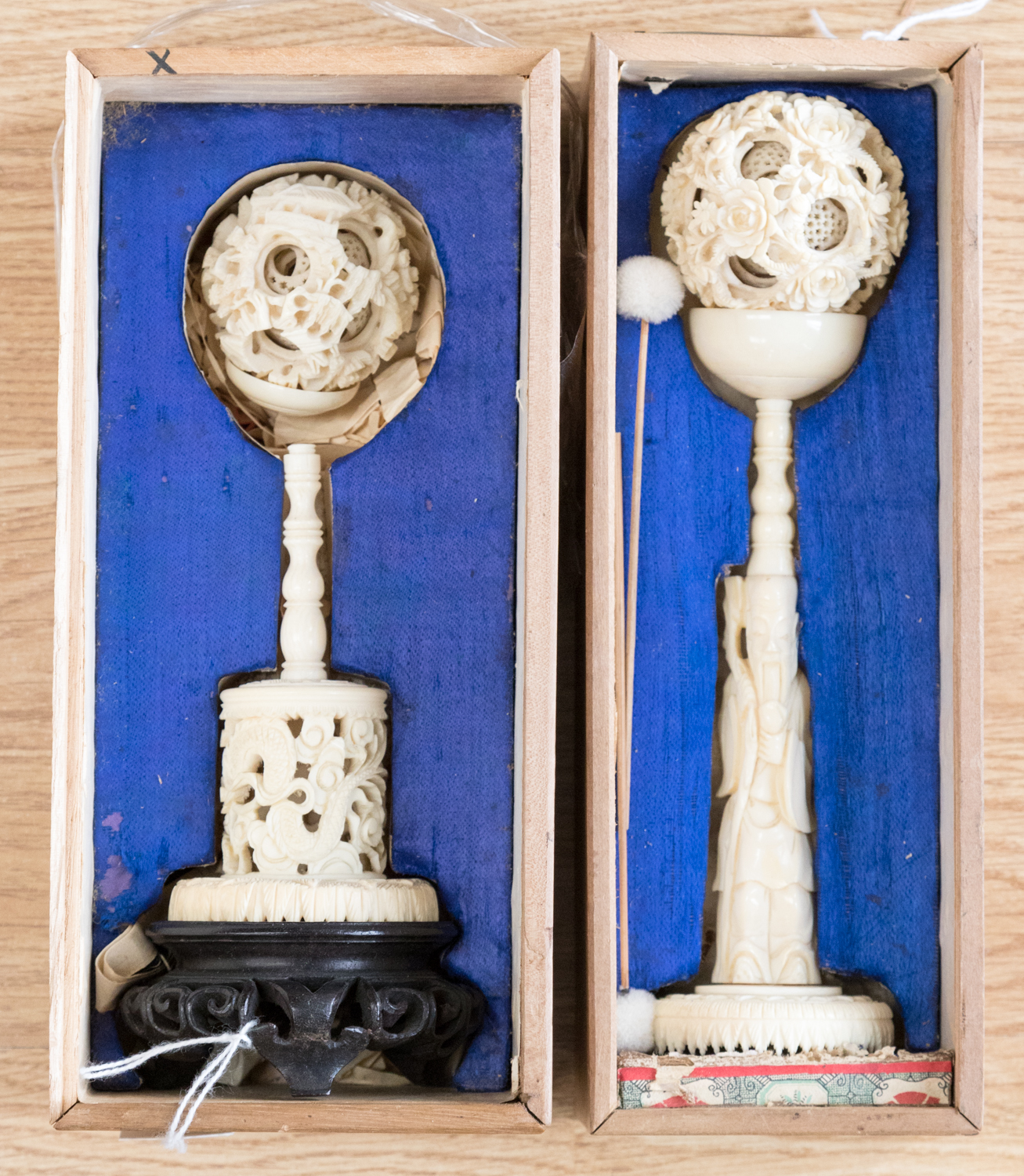 Two early 20th Century boxed Chinese ivory puzzle balls on stands,
