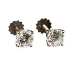 A pair of diamond solitaire white gold stud earrings,