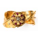 A 1960s diamond and ruby set 18ct gold hinged bangle watch,