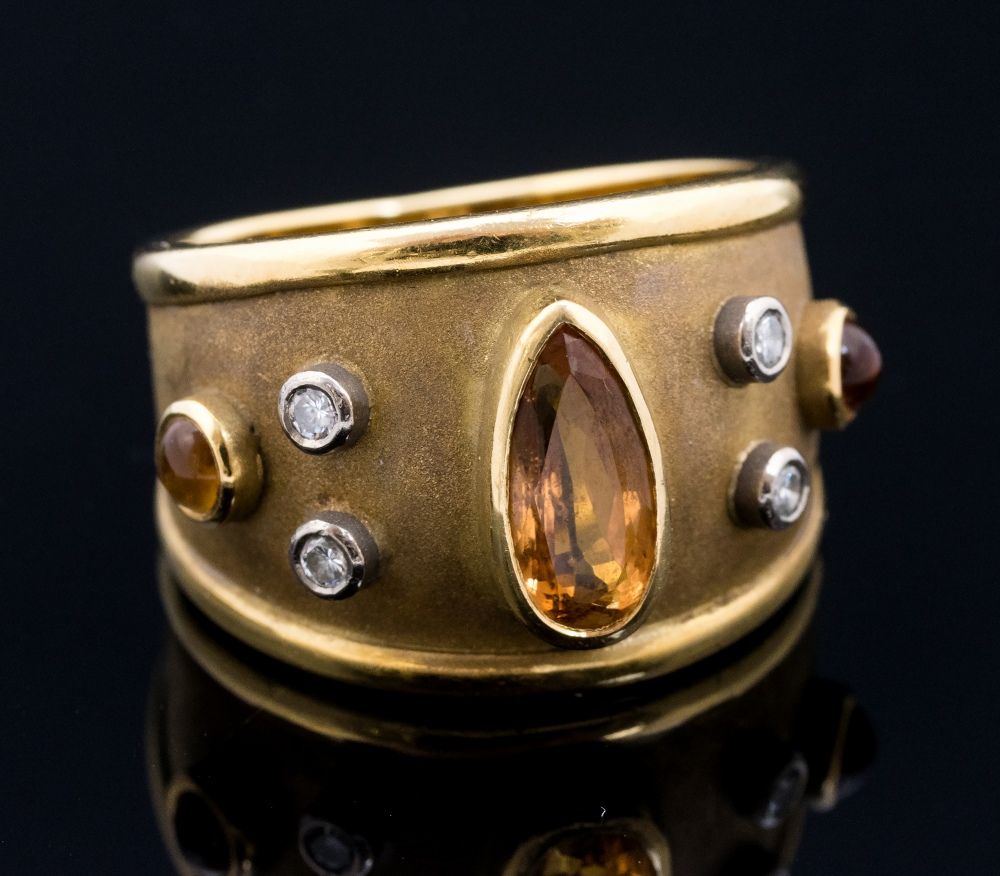 A yellow Imperial topaz and diamond set 18ct gold band ring,