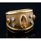 A yellow Imperial topaz and diamond set 18ct gold band ring,