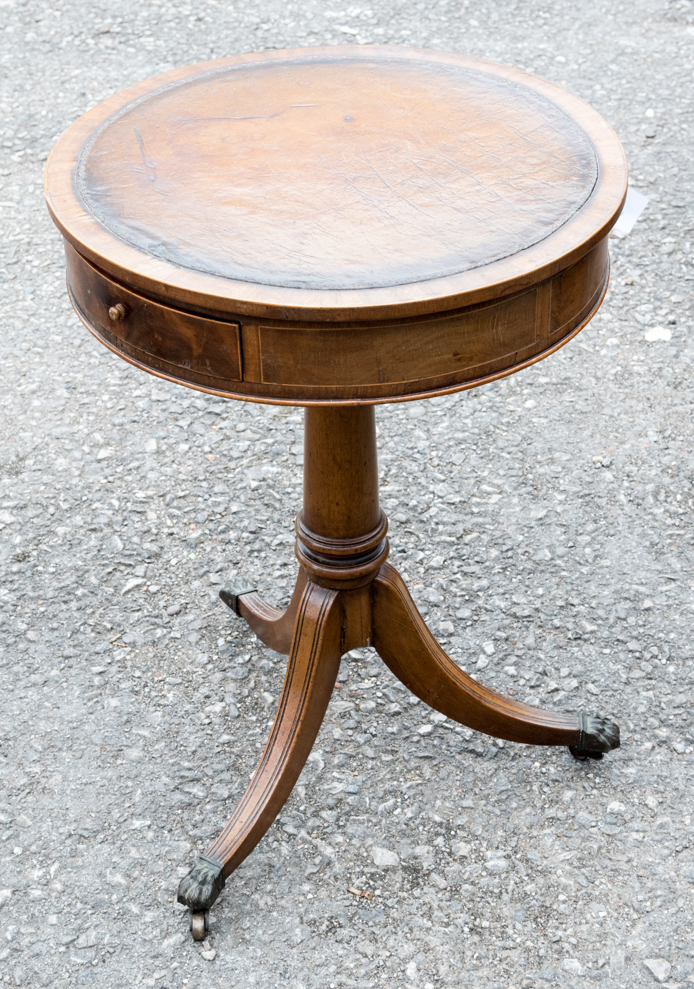 A 19th Century pedestal drum table, the circular top with an inset leather writing surface,