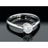 A diamond solitaire 18ct white gold ring, the round brilliant cut diamond weighing approximately 0.