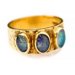 A black opal three stone 18ct gold band ring, hallmarked for 1971,