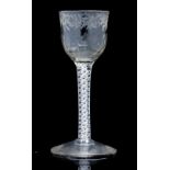 An 18th century opaque twist wine glass, the ogee bowl with moulded fluting to the lower half,