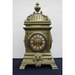 A late 19th Century French brass bracket clock, the case of Baroque design, finial and cupola,