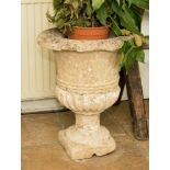 A limestone campana urn planter