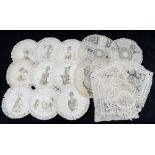 A box of rare hand painted or drawn doilies with silk fringing depicting characters in costume from