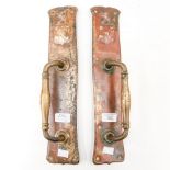 A pair of early 20th Century brass door handles, with coat of arms on top,