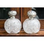 A pair of cut glass and silver topped Victorian scent bottles