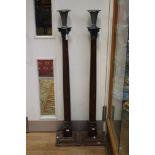 A pair of tall floorstanding candlesticks,