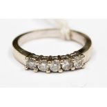 A 14 ct white gold five stone diamond ring, each stone claw set, assessed clarities I1/ I 2,