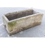 A large concrete planter or trough,