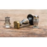 A white metal wax seal stamp in the form of an owl,