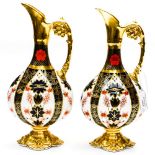 A pair of Royal Crown Derby, Old Imari 1128 pattern, swan neck ewer jugs,