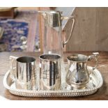 A collection of silver plate including a Edwardian claret jug cut glass with shaped oval tray and