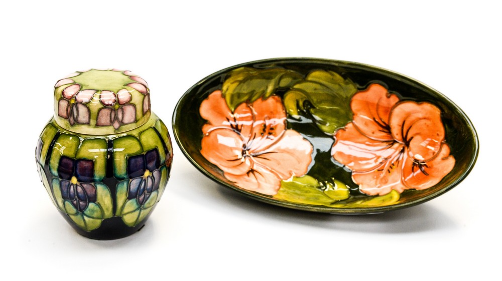 Moorcroft hibiscus pattern elongated dish together with violet pattern ginger jar (2)