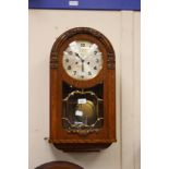 A Jacobean style oak cased German wall clock, circa 1930s, Arabic numerals, W.