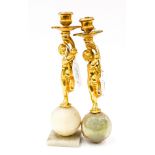 Pair of gilt bronze figural candlesticks on onyx bases,