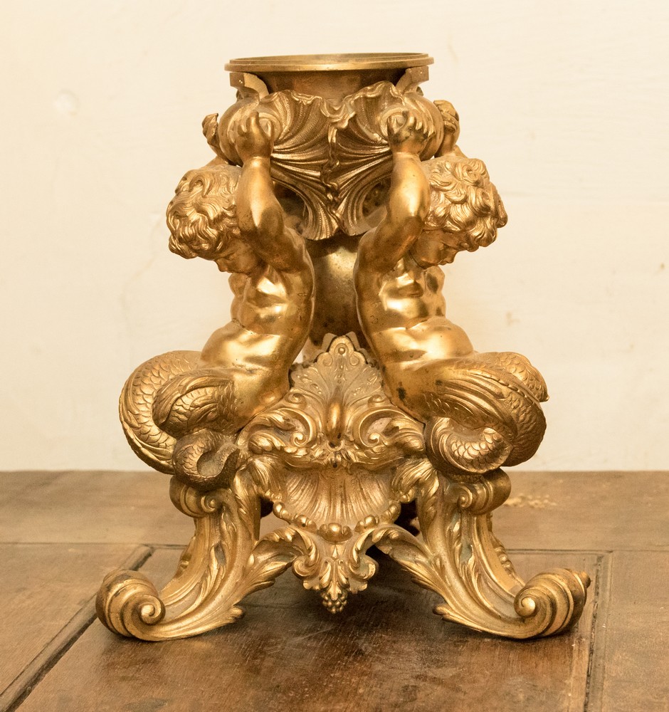 A 19th Century ormolu figural stand in the form of three Mermen putti supporting a mount,