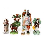 A collection of early Staffordshire figures to include cow and calf, spill vase, Archer,