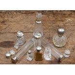 A group of ten silver topped perfume and dressing table bottles, including faceted glass,