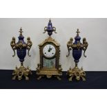 An Italian 'Imperial' brass mantle clock and garniture, the enamelled dial having Roman numerals,