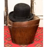 A black bowler hat in leather case,