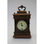 An early 20th Century walnut cased and ormolu mounted mantle clock, enamelled dial,