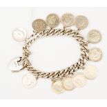 A silver charm bracelet with three penny bits, approx 1.