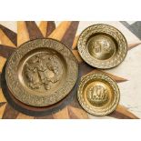 Three large pressed brass alms dishes,