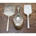A silver Art Deco hand mirror and brush,
