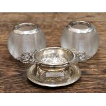 A pair of silver rimmed match strikers and a EPNS tea strainer