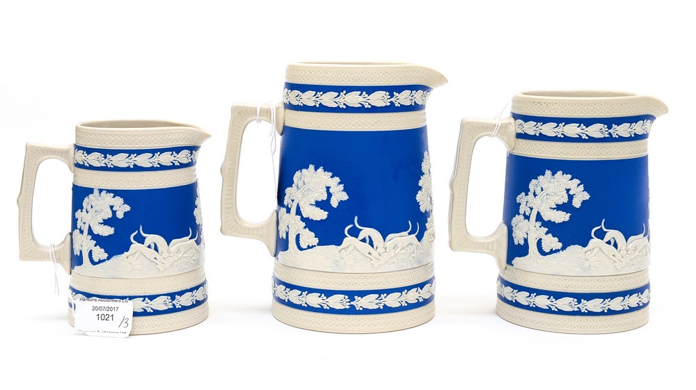 A graduated set of three Copeland jugs, circa 1884 with applied hunting scenes, horses, hounds,