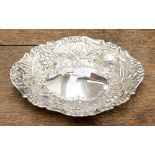 A Victorian oval silver dish with embossed floral and foliate decoration, maker Sibray Hall & Co,