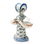 A Delft polychrome double salt in the form of a lady figure with two baskets,