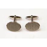 A pair of silver cufflinks