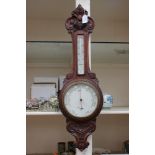 A late 19th Century/Edwardian solid carved mahogany barometer Dolland of London,