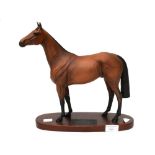 A Beswick figure of Red Rum on a wooden base