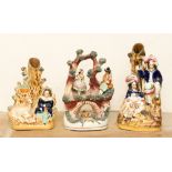 A Staffordshire figure group of dancer and musician over a bridge and two spill vases (3)