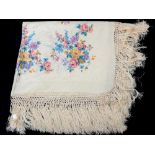 A silk shawl with screen printed floral designs and long fringing,