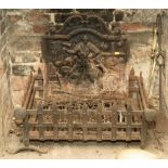 A cast iron fire back and grate,