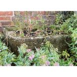 A large sandstone trough planter