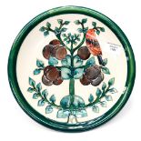 A Moorcroft plate depicting bird in plum tree, WM to base,