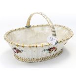 A large porcelain basket, moulded weave design with floral bouquets and gilt banding,