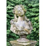 An 18th Century style stone figure of Bacchanalian woman, flowing hair and bare breast,