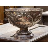 A late Victorian silver circular rose bowl embossed 'C' scrolls and floral frieze,