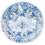 A large blue and white Dutch Delft tin glazed plate decorated with flowers, circa 1740,