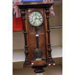 A 19th Century walnut cased Vienna wall clock, with cream enamelled chapter dial,